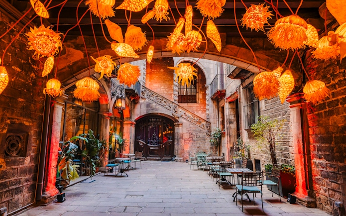 Outdoor seating area at Palau Dalmases Flamenco Show with decorative lights.