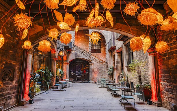 Outdoor seating area at Palau Dalmases Flamenco Show with decorative lights.