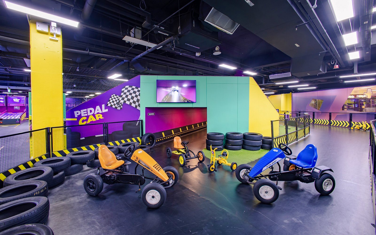 Go-karting track with pedal cars at SuperPark Singapore indoor arena.