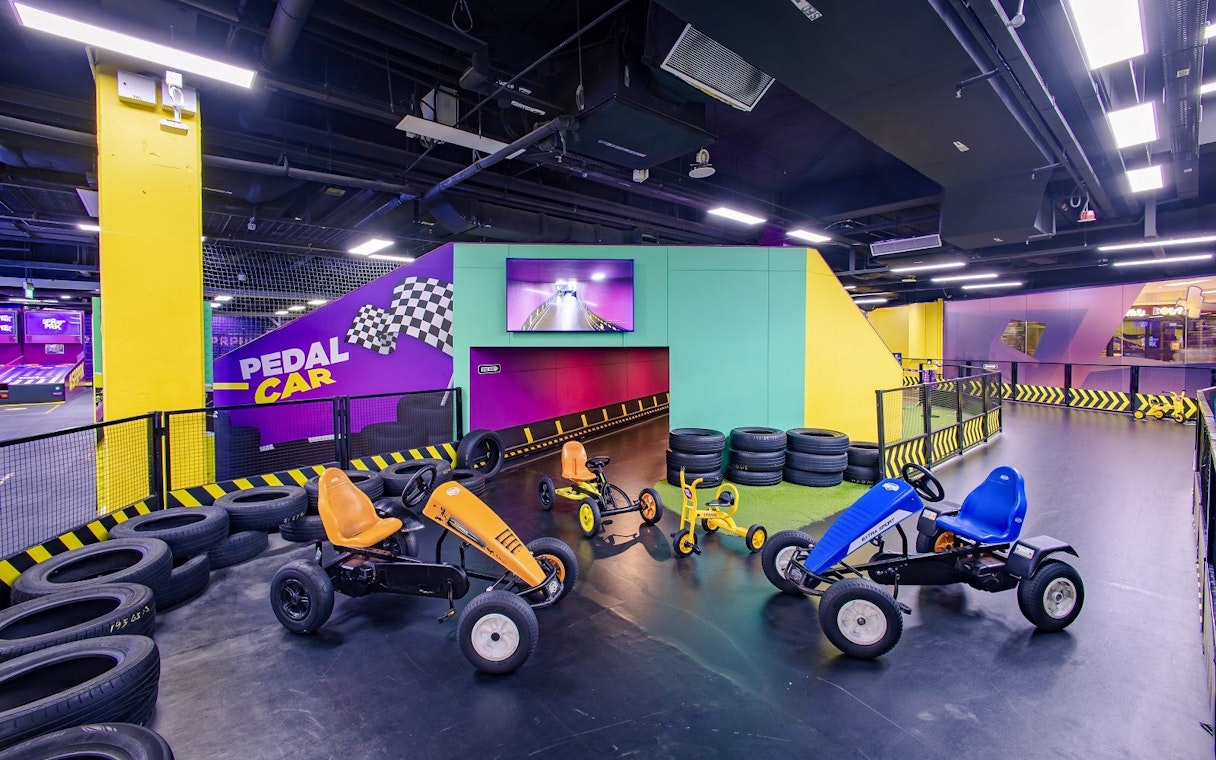 Go-karting track with pedal cars at SuperPark Singapore indoor arena.