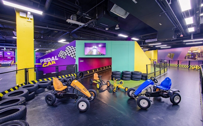 Go-karting track with pedal cars at SuperPark Singapore indoor arena.