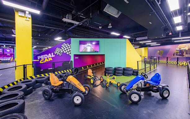 Go-karting track with pedal cars at SuperPark Singapore indoor arena.