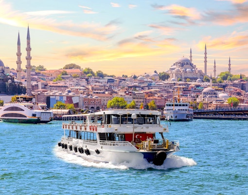 Bosphorus Cruise ship sailing past Istanbul's iconic skyline with historic mosques and bridges in view.