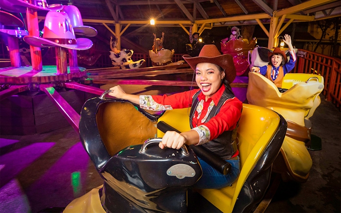 Visitors enjoying a cowboy-themed ride at Sunway Lagoon Theme Park, Malaysia.