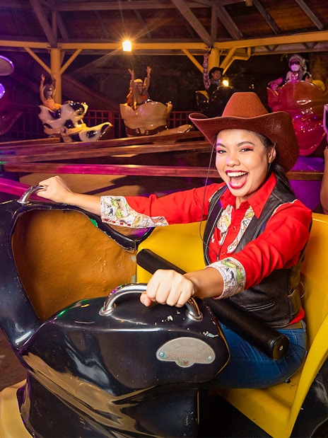 Visitors enjoying a cowboy-themed ride at Sunway Lagoon Theme Park, Malaysia.