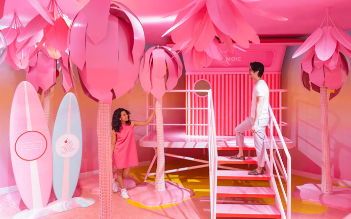 Visitors exploring vibrant pink room at Museum of Ice Cream, Singapore.