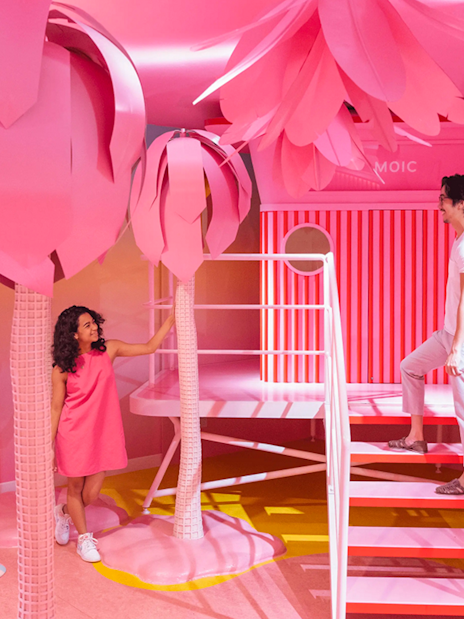 Visitors exploring vibrant pink room at Museum of Ice Cream, Singapore.