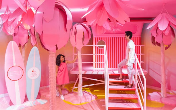 Visitors exploring vibrant pink room at Museum of Ice Cream, Singapore.