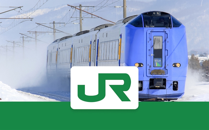 Blue train traveling through snowy Hokkaido landscape with JR logo.