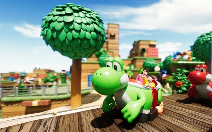 Visitors enjoying a Yoshi-themed ride at Universal Studios Japan.