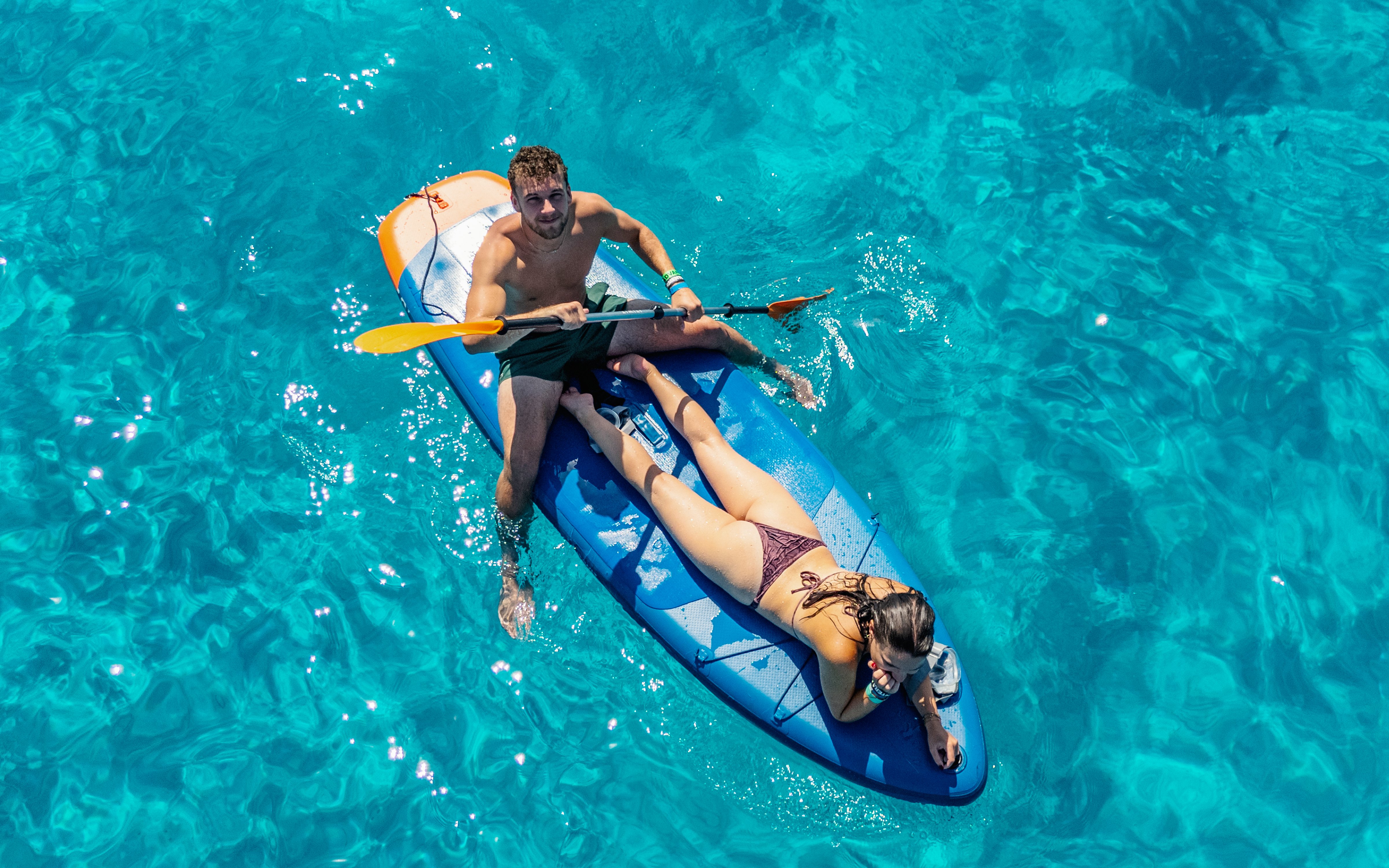 Couple kayaking on clear blue waters during Formentera Cruise Tour.