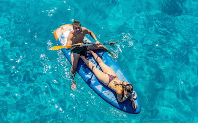 Couple kayaking on clear blue waters during Formentera Cruise Tour.