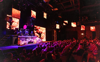 Blue Man Group performing on stage with vibrant visuals in Orlando theater.