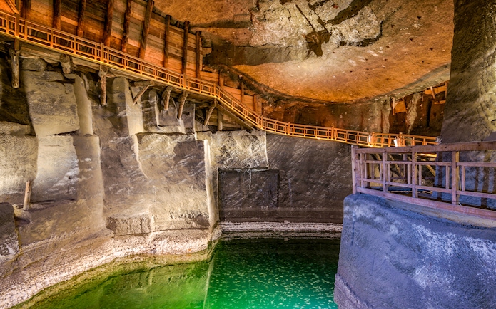 Underground lake with wooden walkways in Wieliczka Salt Mine, Poland.