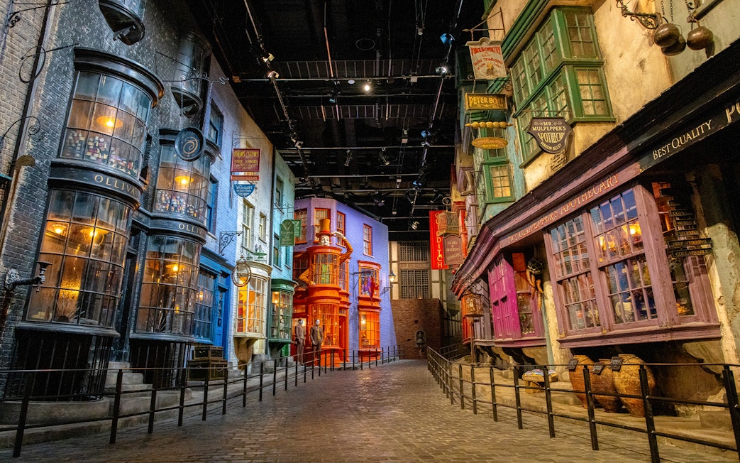 Diagon Alley at Warner Bros. Studio Tour Tokyo, featuring colorful shopfronts and cobblestone street.