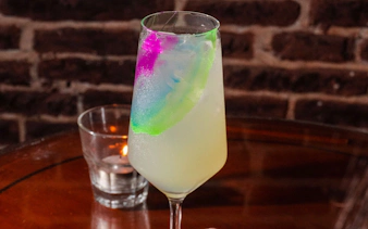 Cocktail with colorful garnish served at Michelangelo Tango Show.