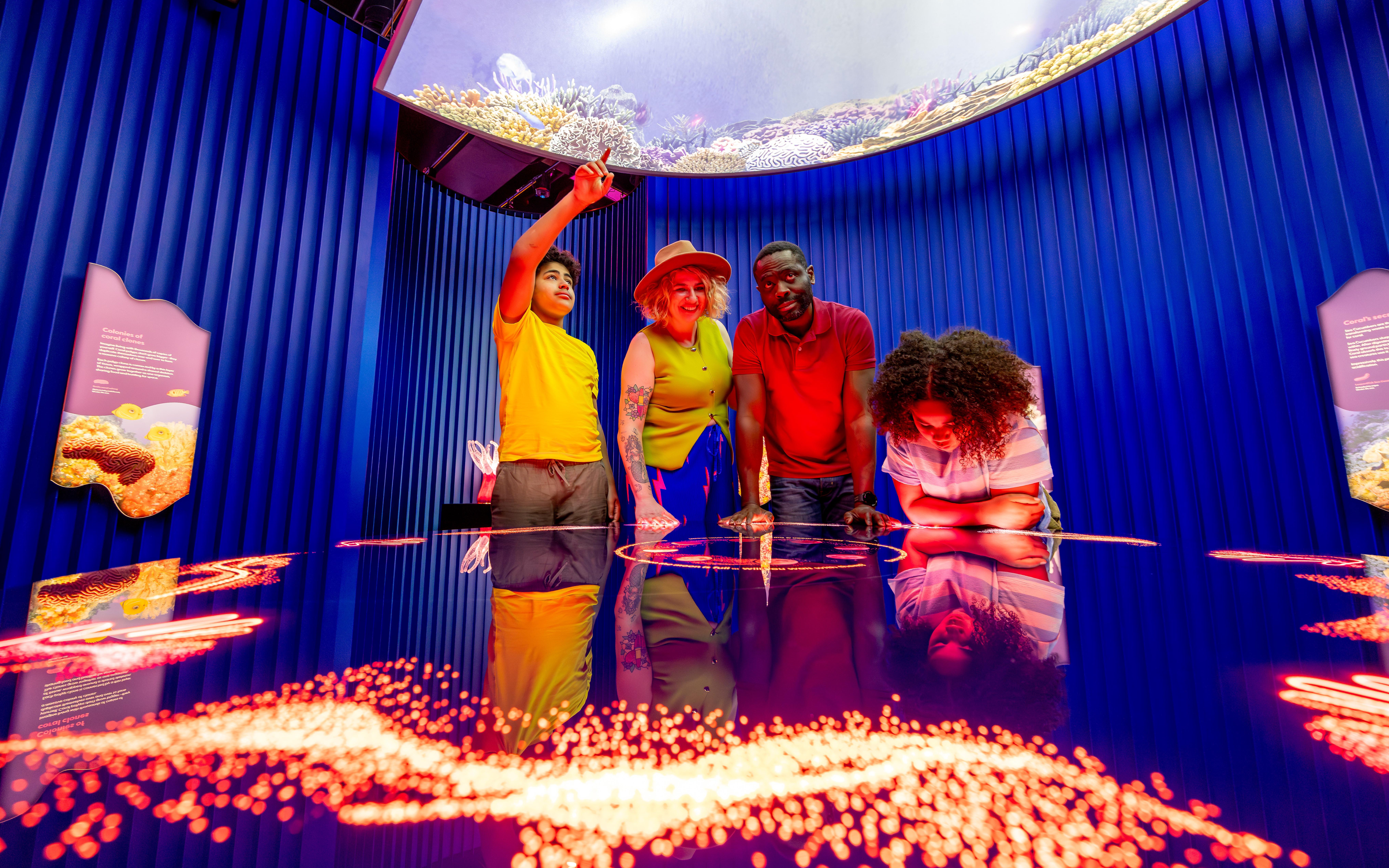 Family exploring "Our Wondrous Planet" exhibit at Melbourne Museum.