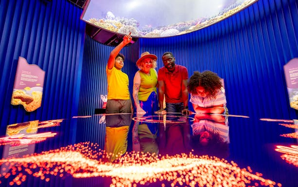 Family exploring "Our Wondrous Planet" exhibit at Melbourne Museum.