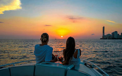 Tourists enjoying sunset on a boat in Cartagena Bay.
