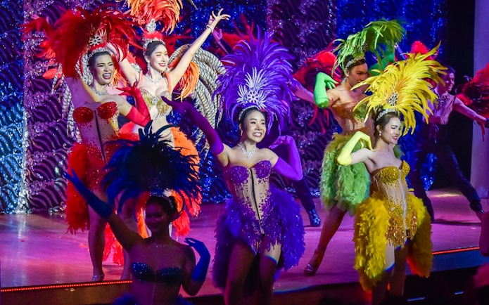 Performers in colorful costumes at the Golden Dome Cabaret Show.