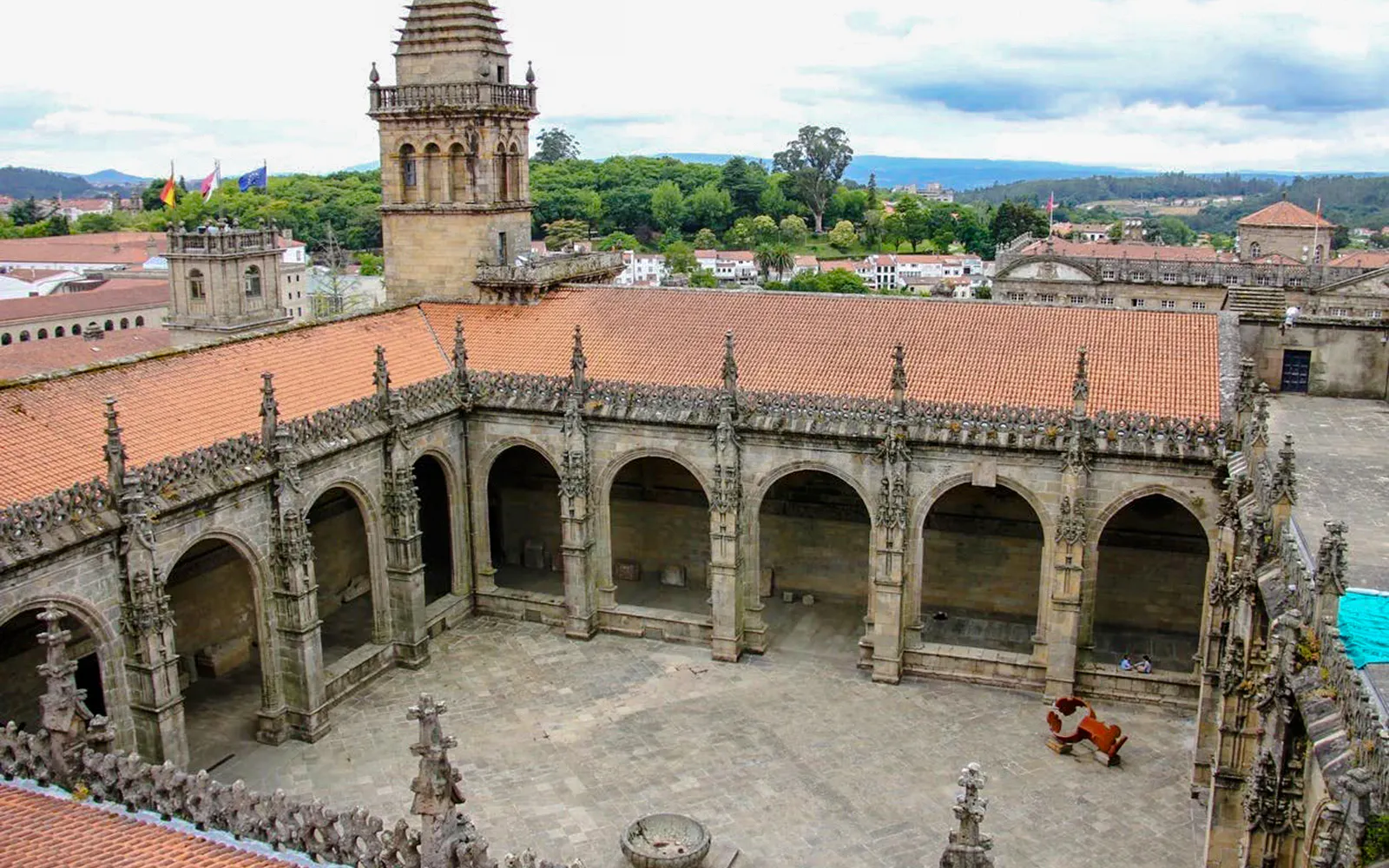 Cloister courtyard of Santiago de Compostela Cathedral, Spain, with arched stone architecture.