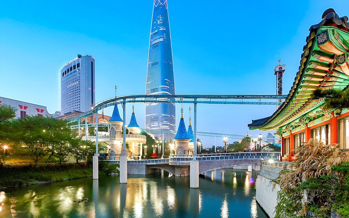 Lotte World park with monorail, traditional Korean architecture, and skyscraper in Seoul.