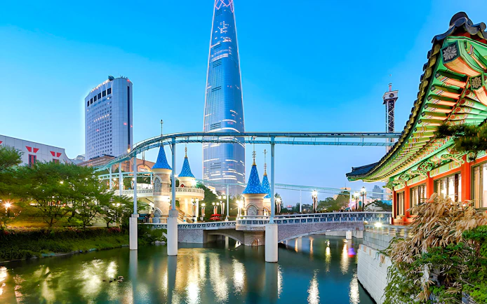 Lotte World park with monorail, traditional Korean architecture, and skyscraper in Seoul.