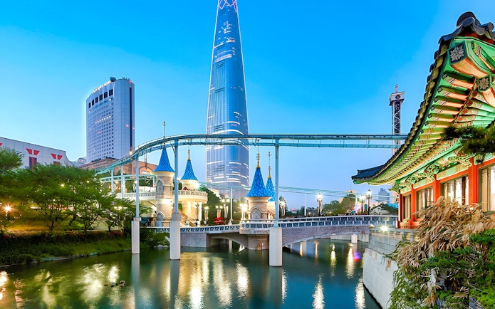 Lotte World park with monorail, traditional Korean architecture, and skyscraper in Seoul.