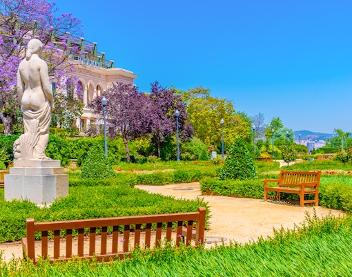 Jardins del Mirador overlooking Barcelona cityscape with distant Sagrada Familia.