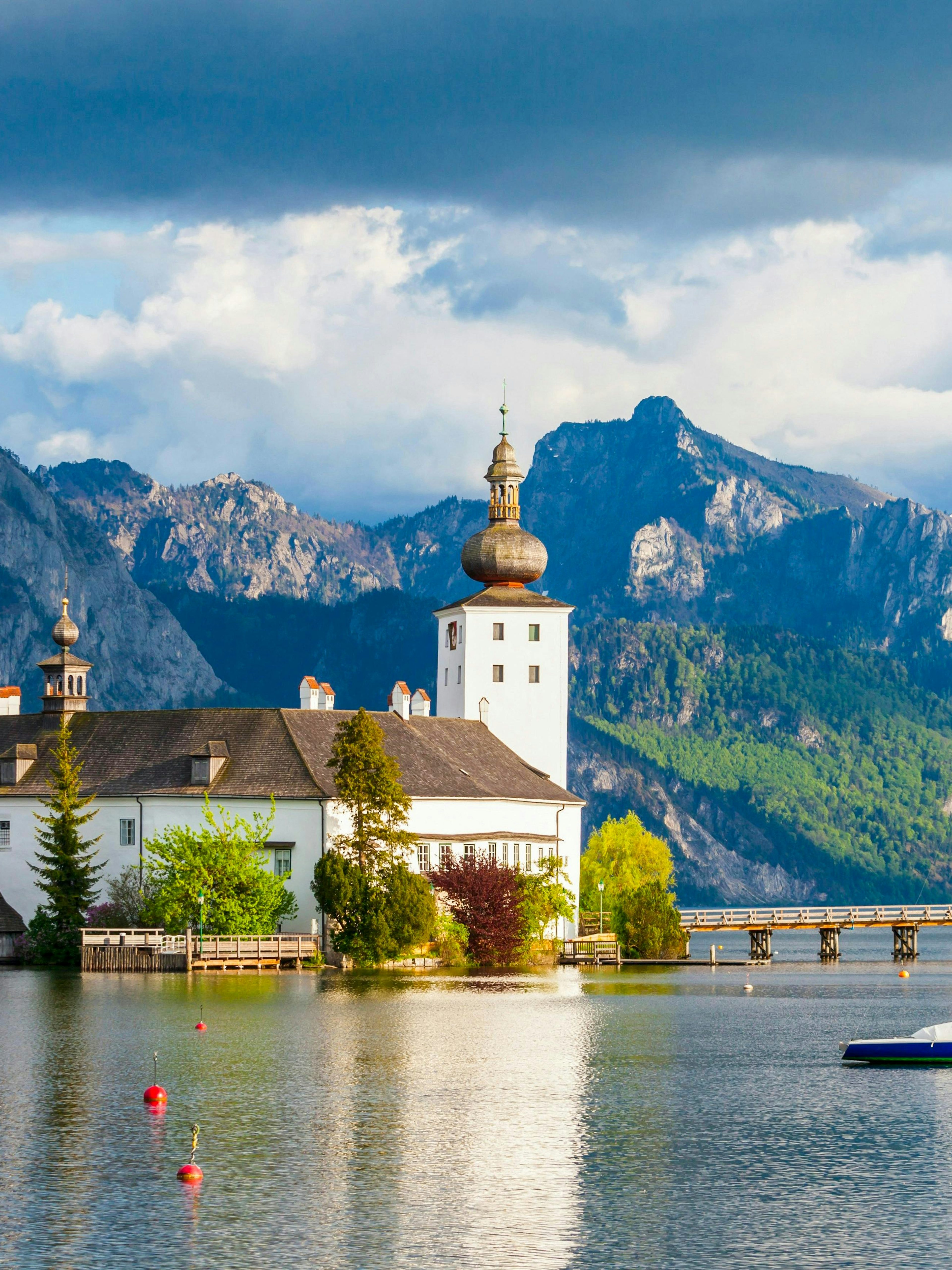 Schloss Ort on Lake Traunsee with mountains in Hallstatt, Austria.