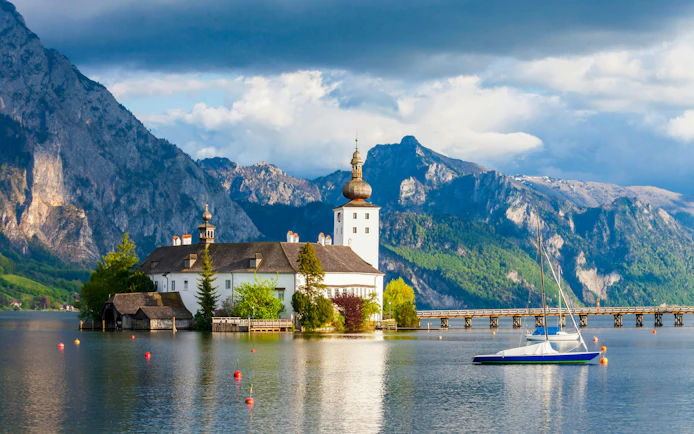 Schloss Ort on Lake Traunsee with mountains in Hallstatt, Austria.