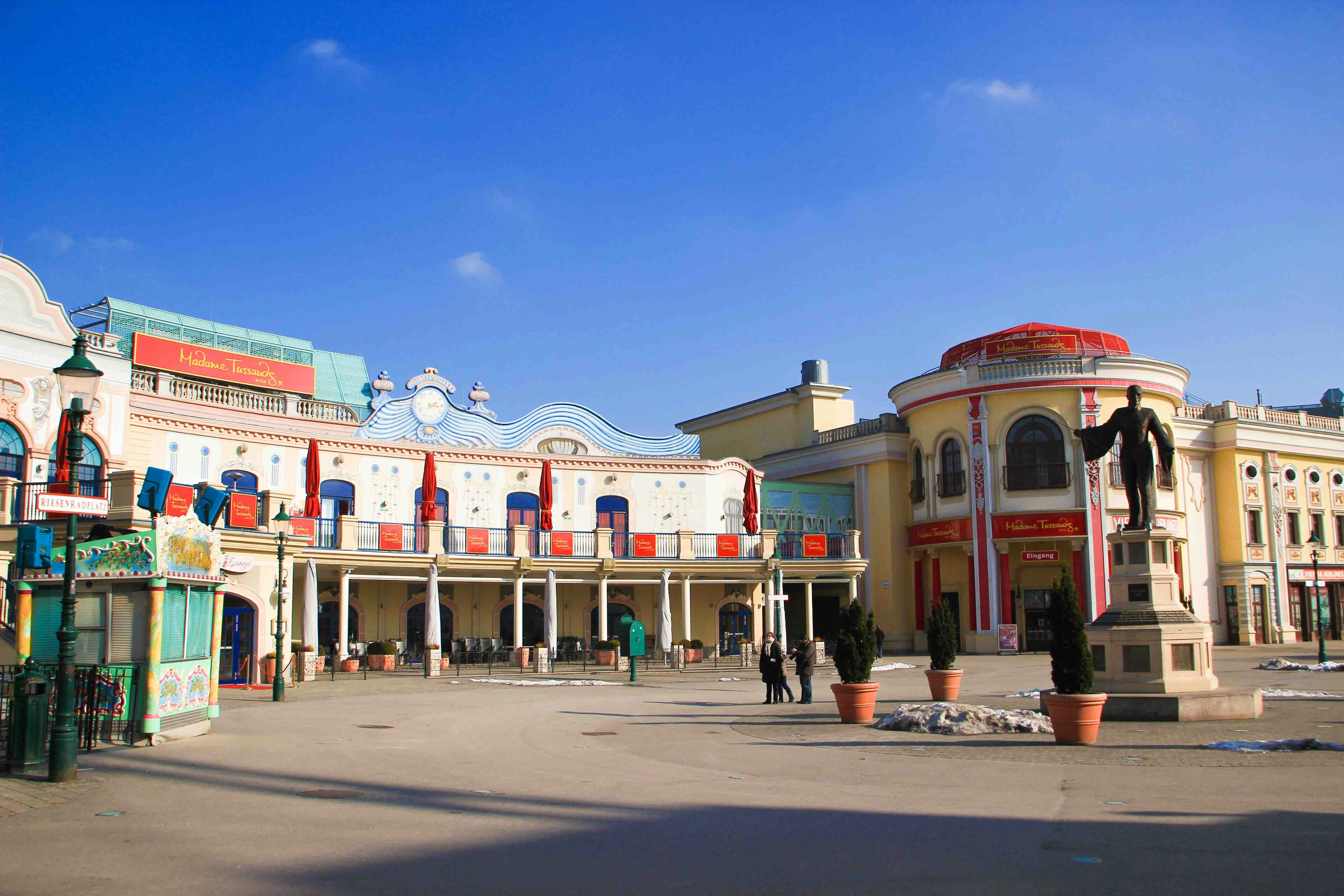 Madame Tussauds Vienna entrance with colorful facade and statue in front.