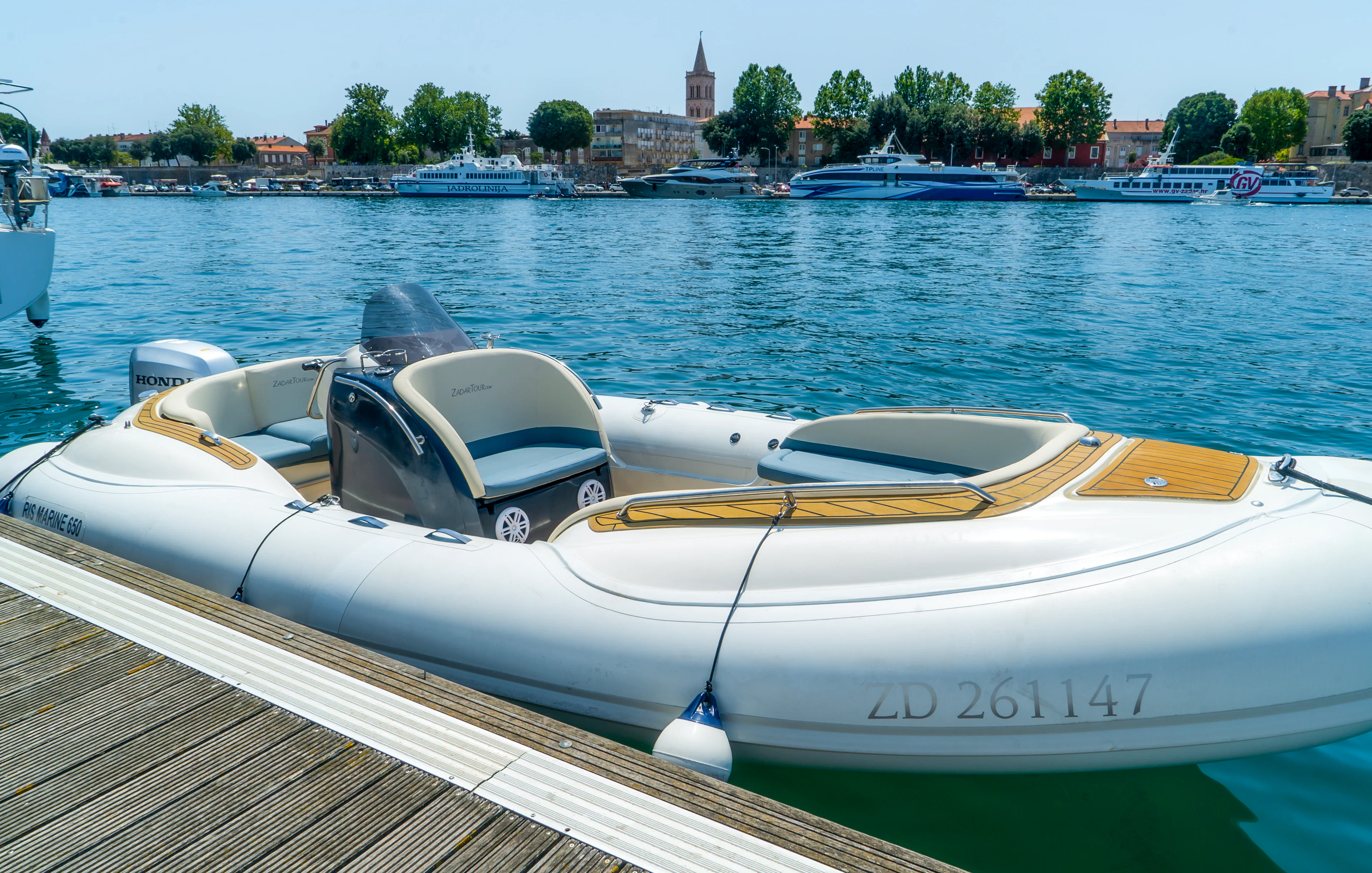 Speedboat docked in Zadar harbor, Croatia, ready for guided tour with local food and wine tasting.