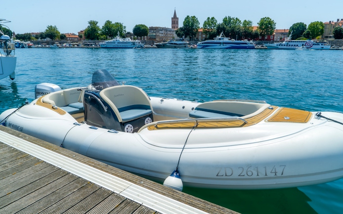 Speedboat docked in Zadar harbor, Croatia, ready for guided tour with local food and wine tasting.