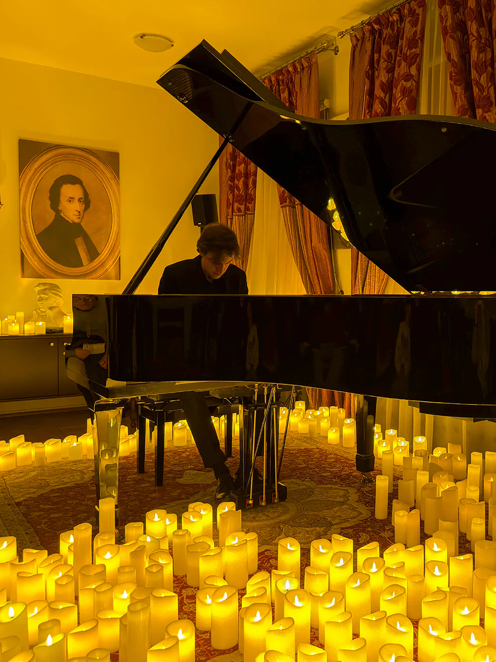 Pianist performing at candlelit Chopin concert in Krakow.