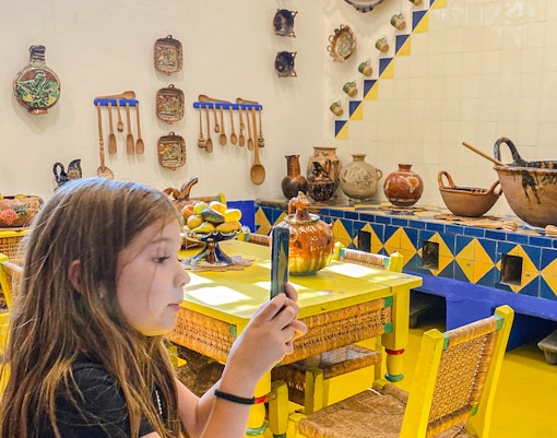 Frida Kahlo Museum kitchen with traditional pottery and utensils on display.