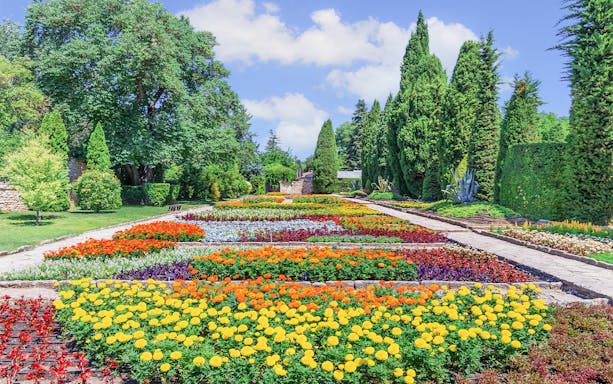 Colorful flower garden in Balchik, Bulgaria, with vibrant blooms and lush greenery.