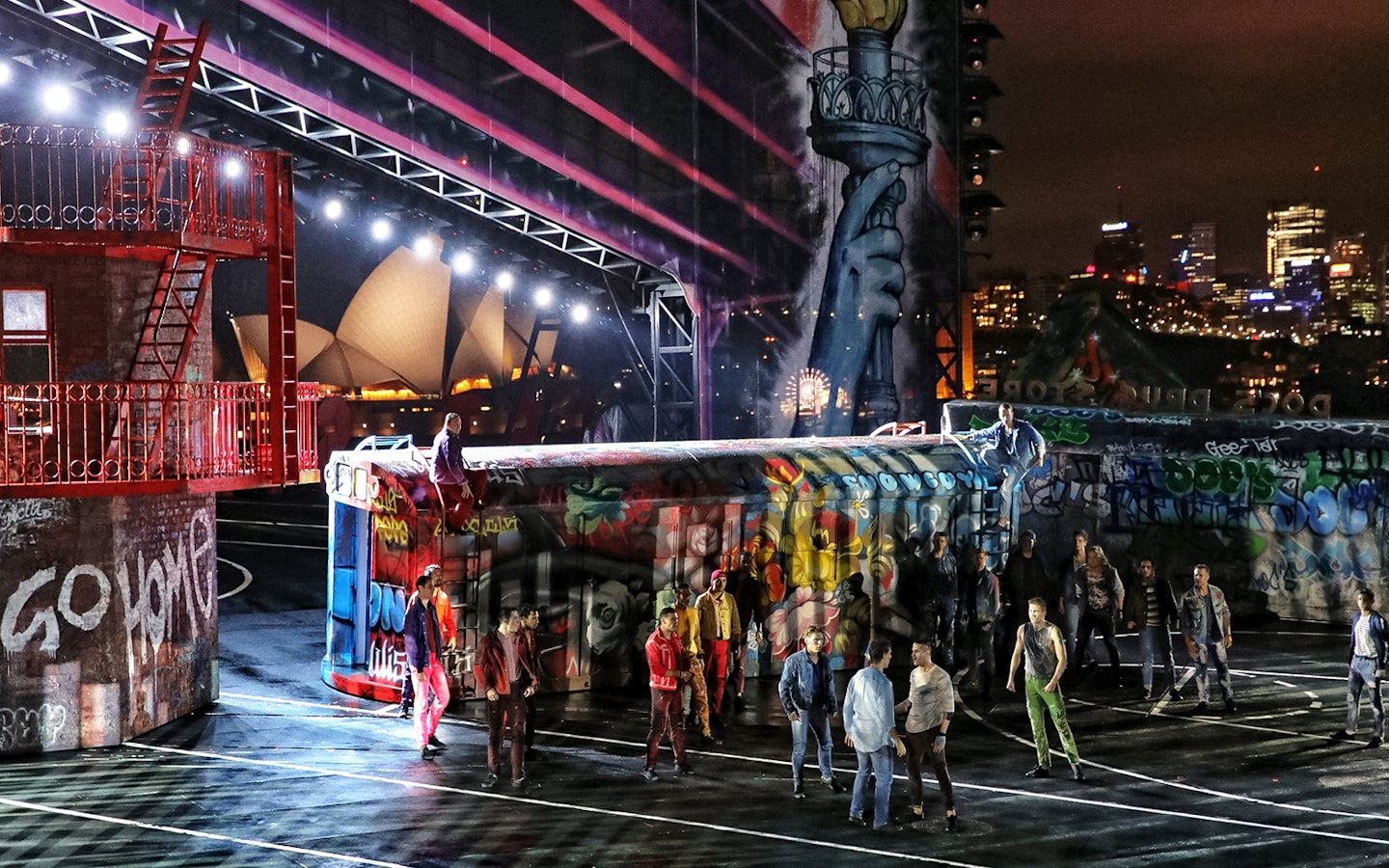Outdoor performance of West Side Story on Sydney Harbour with Sydney Opera House in the background.
