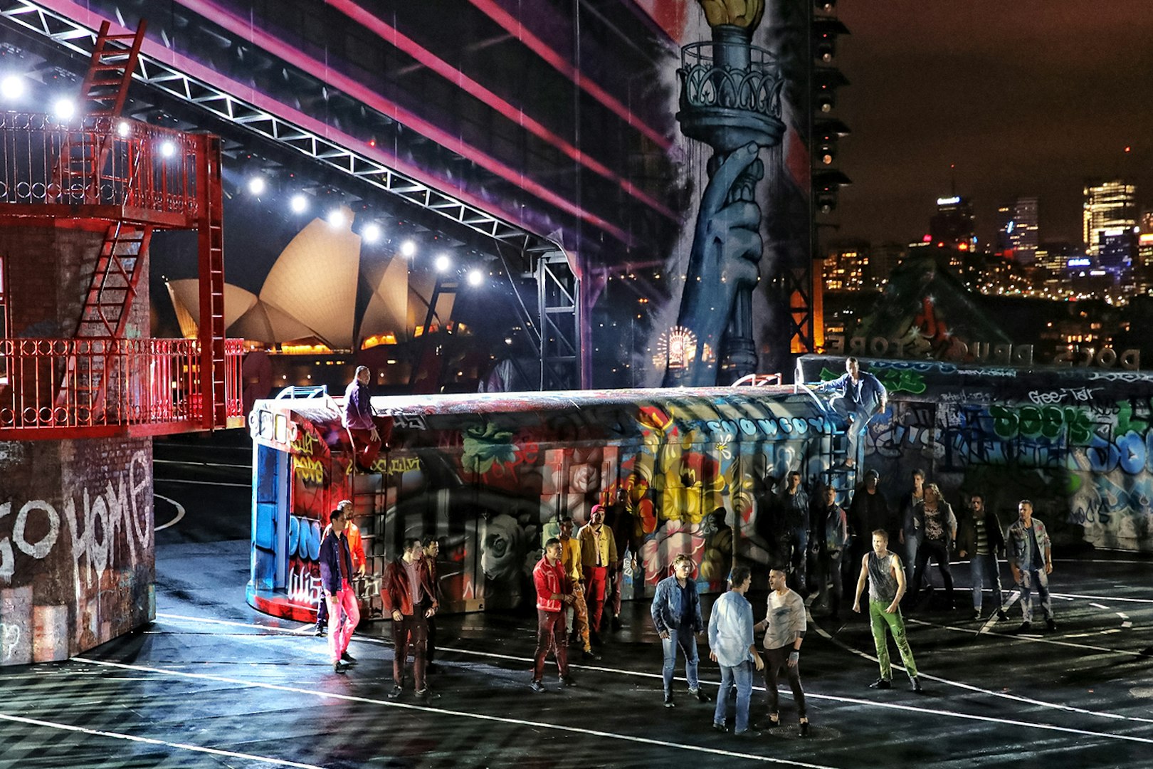 Outdoor performance of West Side Story on Sydney Harbour with Sydney Opera House in the background.