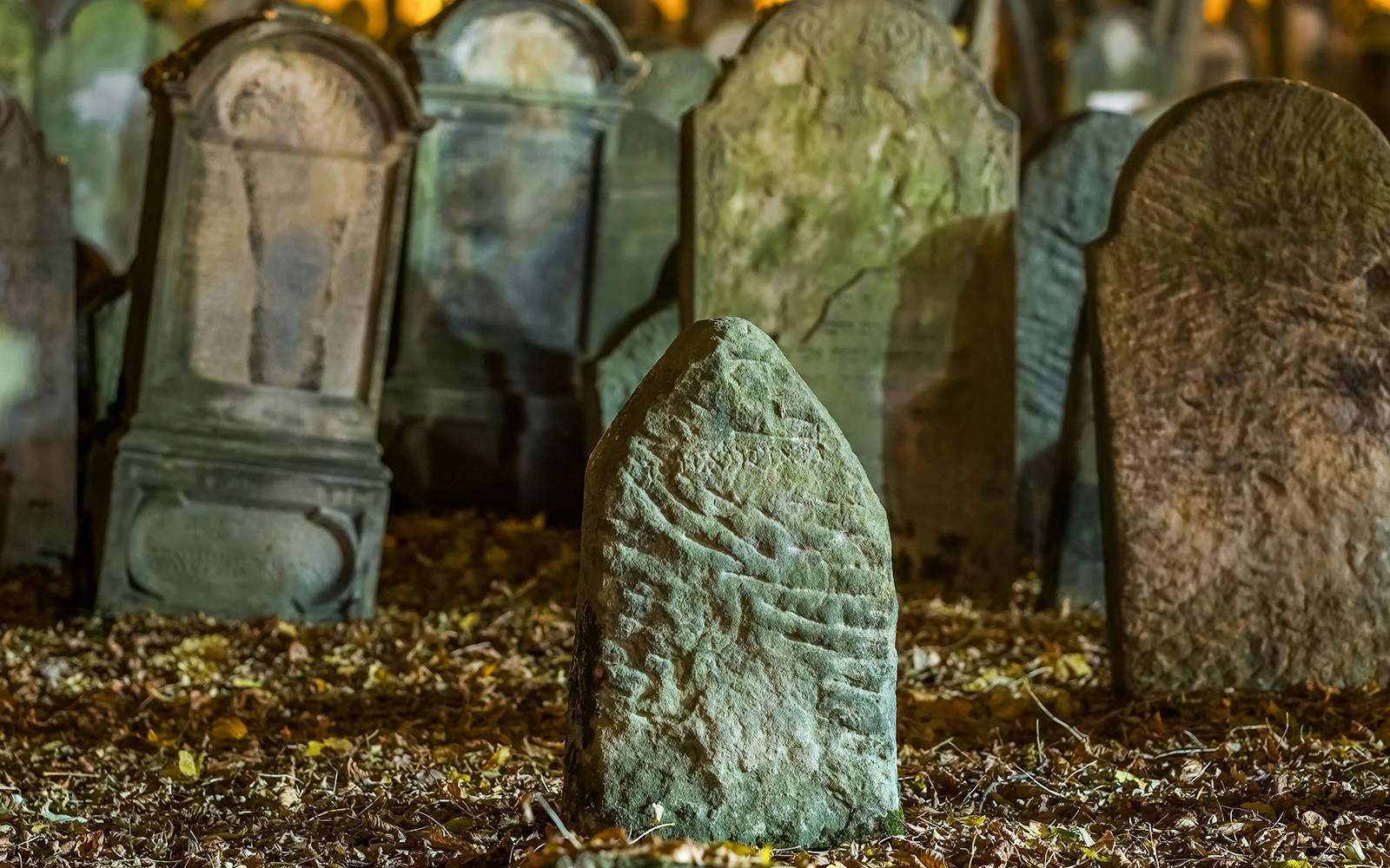 Tombstones in an old cemetery at night