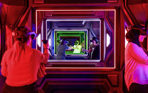 Visitors engaging in virtual reality gaming at Pixoul Gaming.