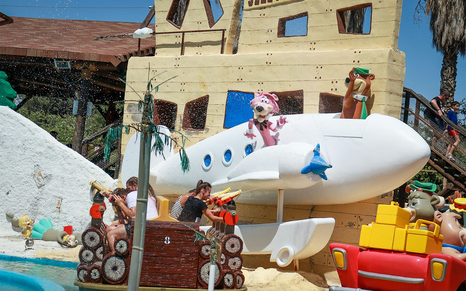 Parque Warner Madrid roller coaster with vibrant cartoon character decorations.