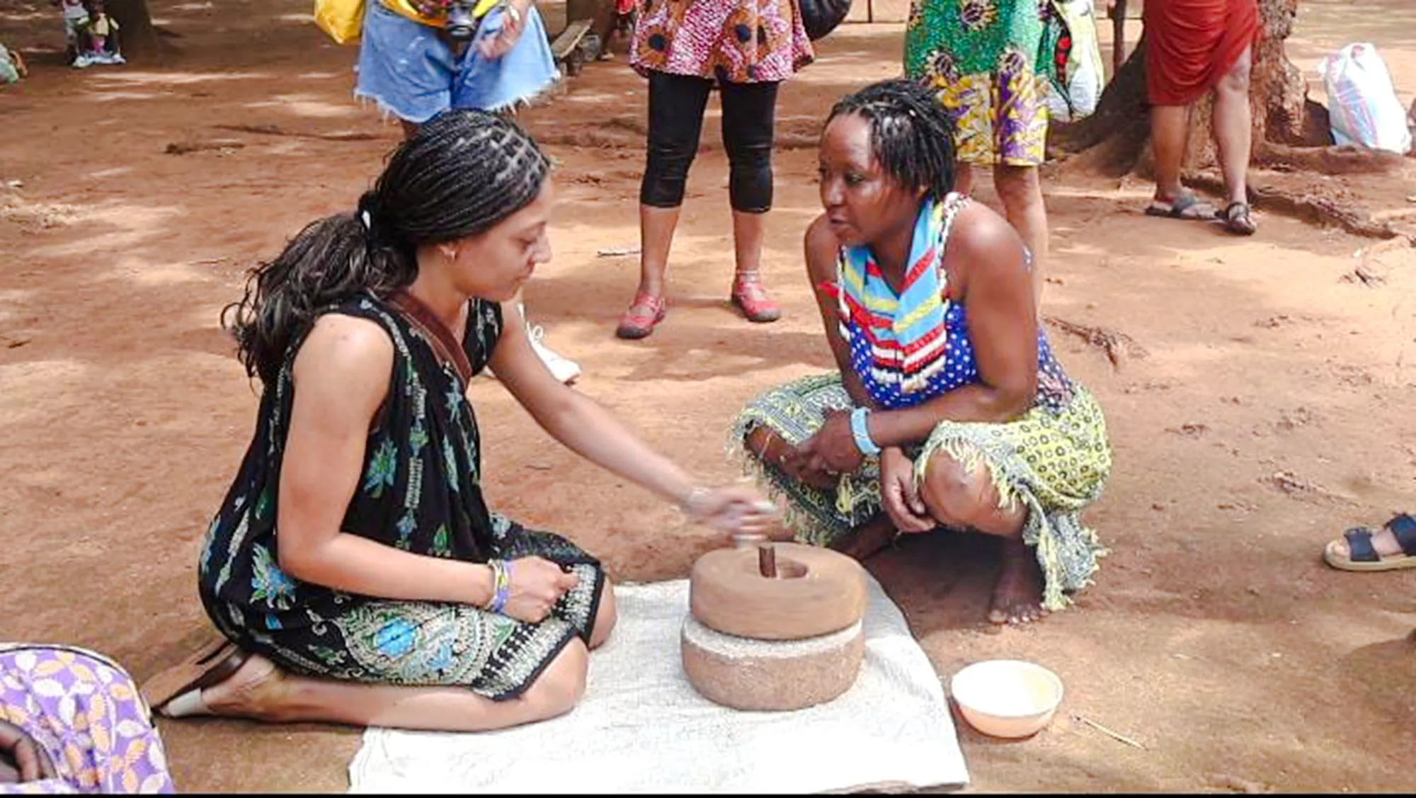 Women demonstrating traditional grinding technique at Duruma village, Diani Beach.