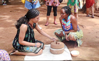 Women demonstrating traditional grinding technique at Duruma village, Diani Beach.
