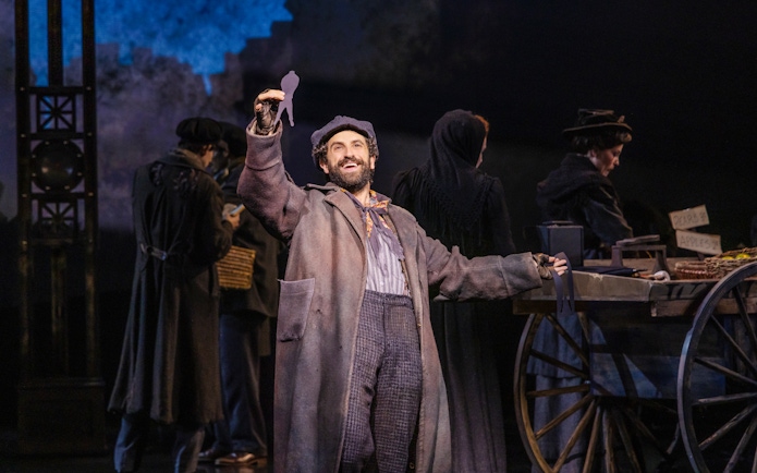 Performer holding silhouette in Ragtime musical scene.