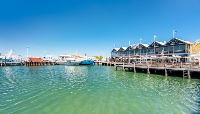 Fremantle Harbour with boats docked and waterfront buildings, Australia.