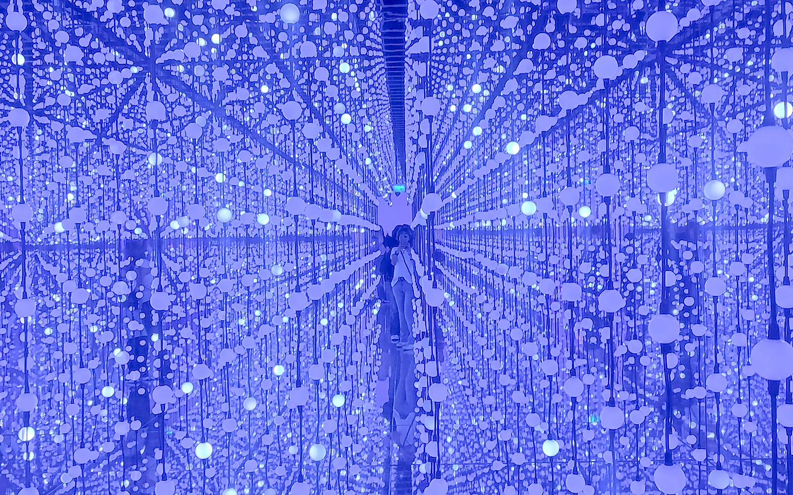 Bubble Planet interior with reflective surfaces and hanging illuminated spheres.