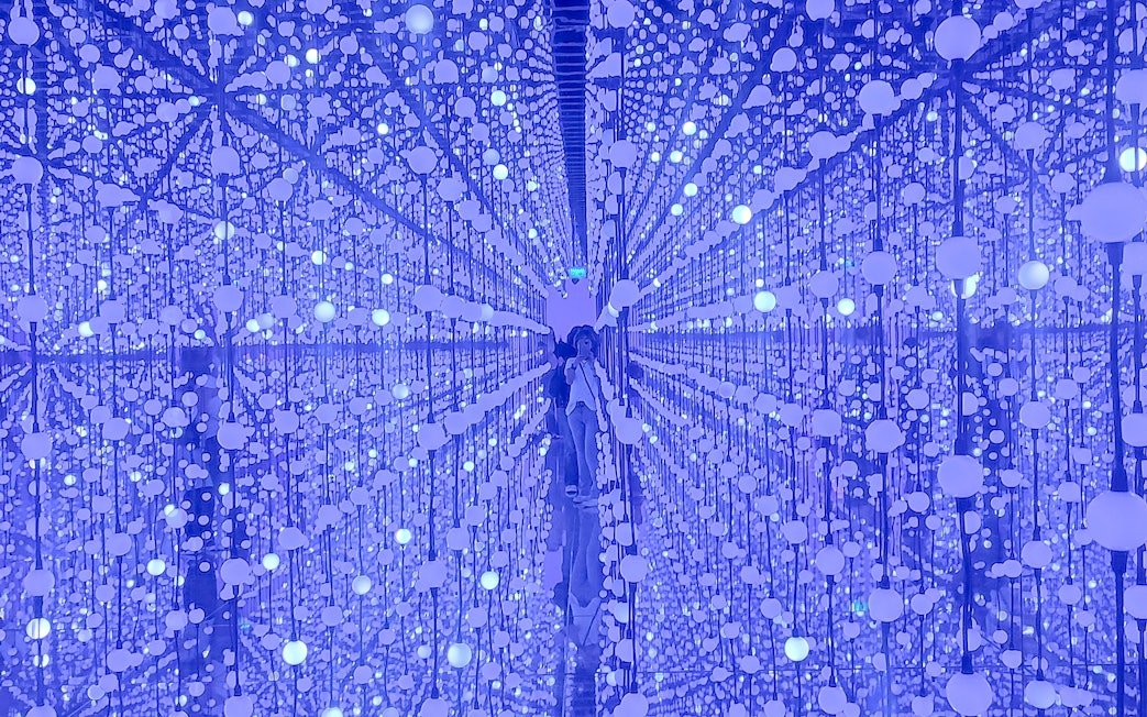 Bubble Planet interior with reflective surfaces and hanging illuminated spheres.