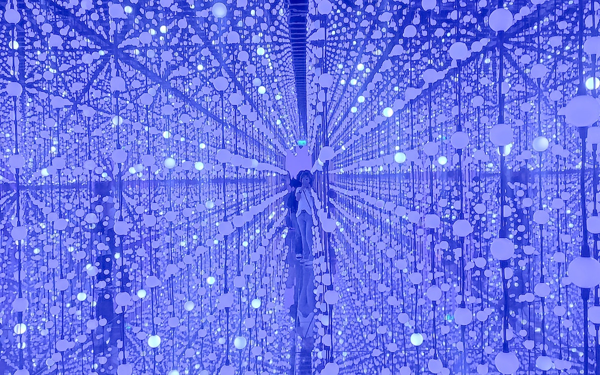 Bubble Planet interior with reflective surfaces and hanging illuminated spheres.