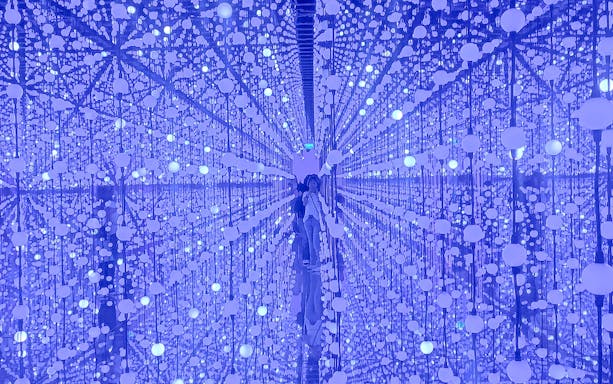 Bubble Planet interior with reflective surfaces and hanging illuminated spheres.